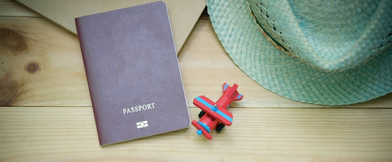 A passport next to a toy plane