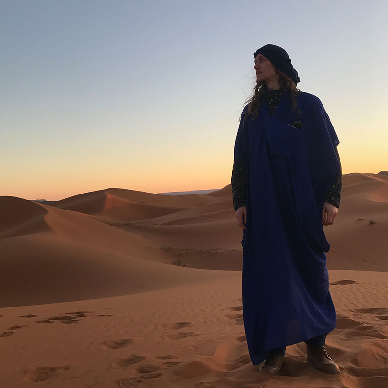Aubrey Inkster stands in Moroccan sand dunes