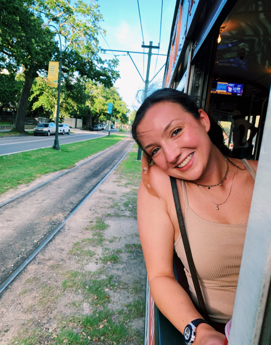 woman smiling while riding tram