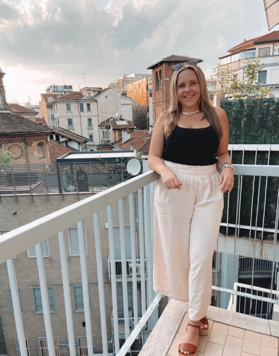 woman on balcony in front of city view