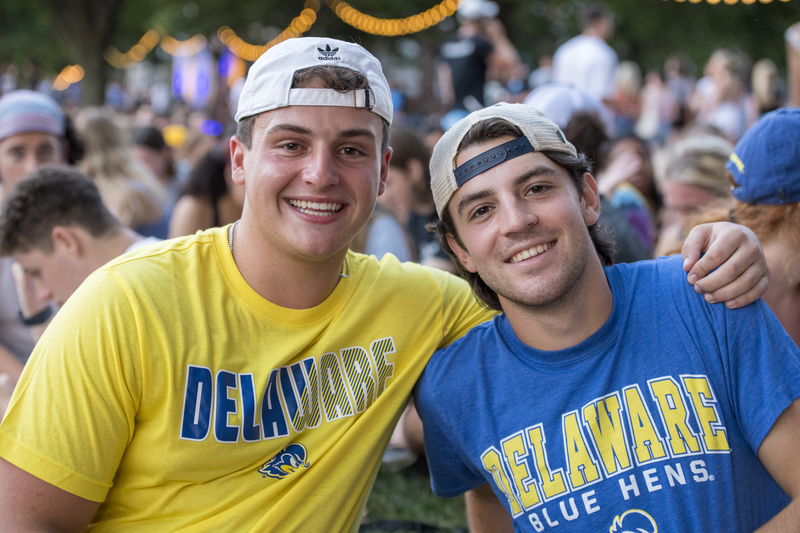 two smiling students wearing UD shirts