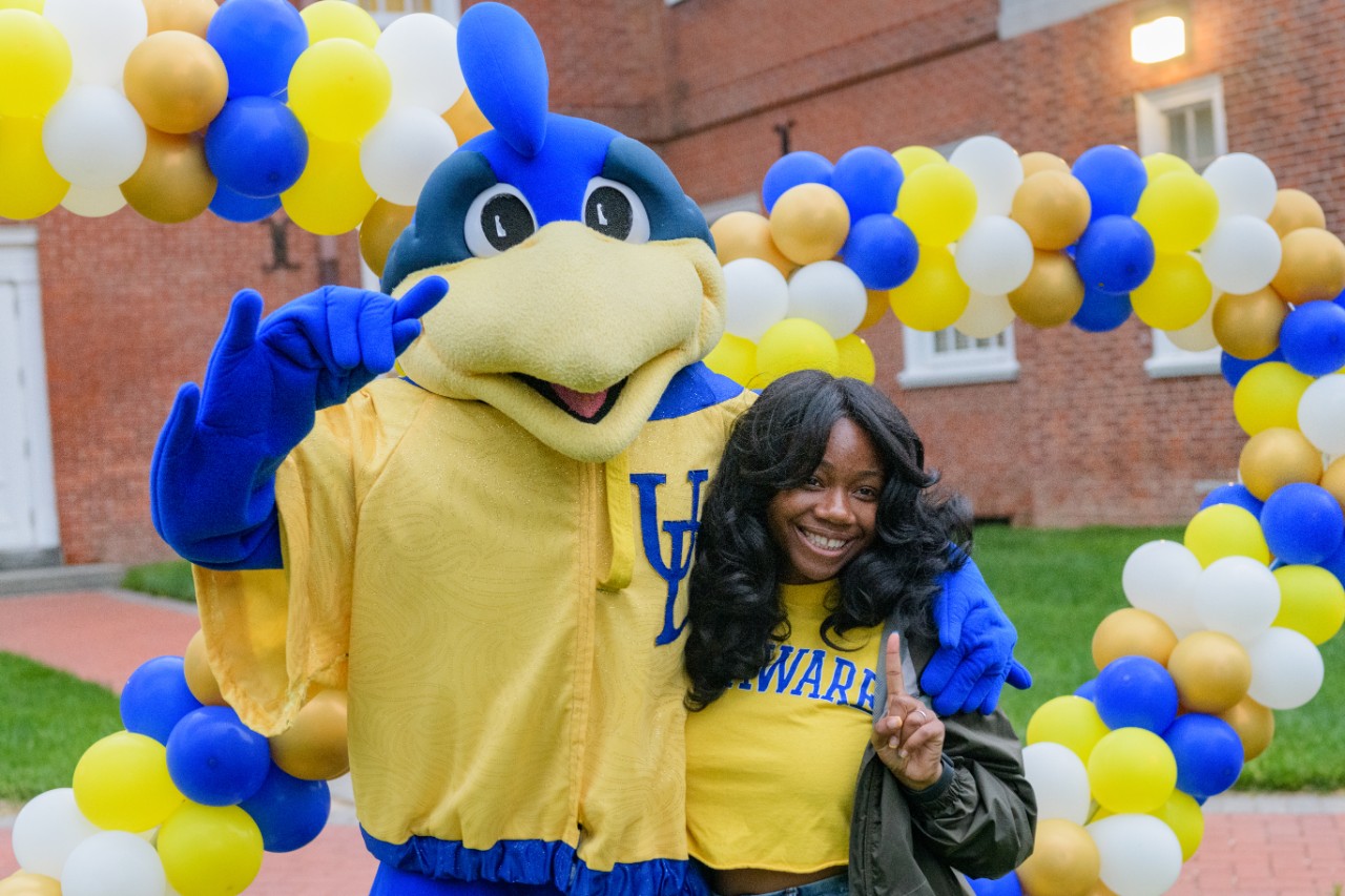 two smiling students wearing UD shirts
