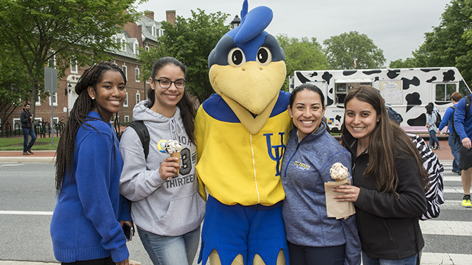 Student pose with YouDee and their UDairy ice cream. 