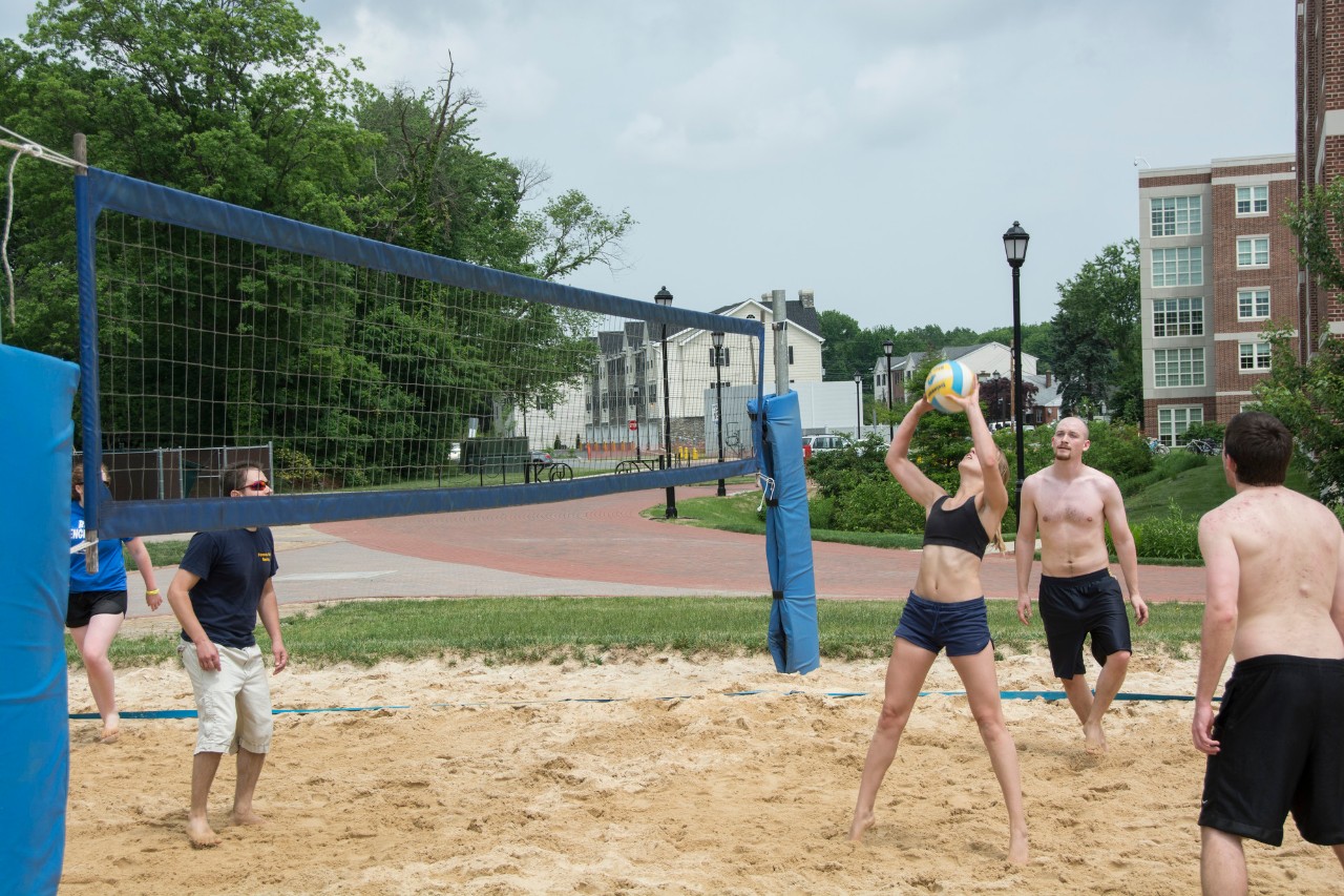 Students play volleyball on the Beach. 