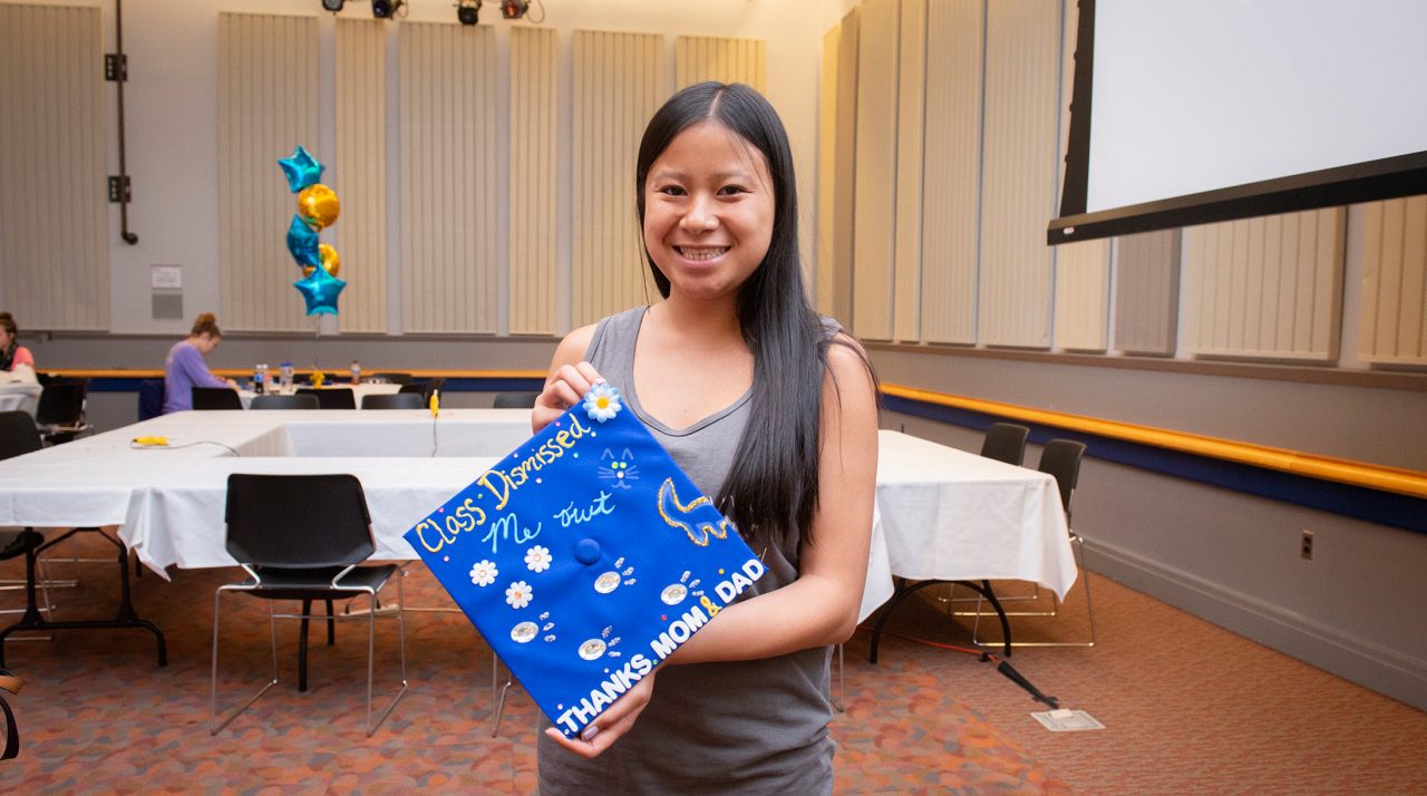 A student shows off her decorated graduation cap at an event sponsored by DAR.