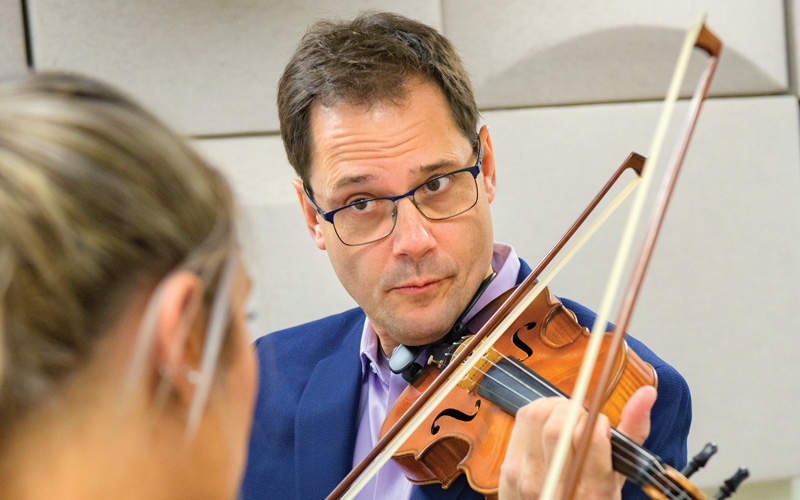 CAS-Music-Combet_Violin_Instruction-022420 Guillaume Combet is an associate professor of violin for the School of Music in the College of Arts and Sciences. Photographed for the President's Report while teaching a group lesson in Loudis Recital Hall and an individual lesson.