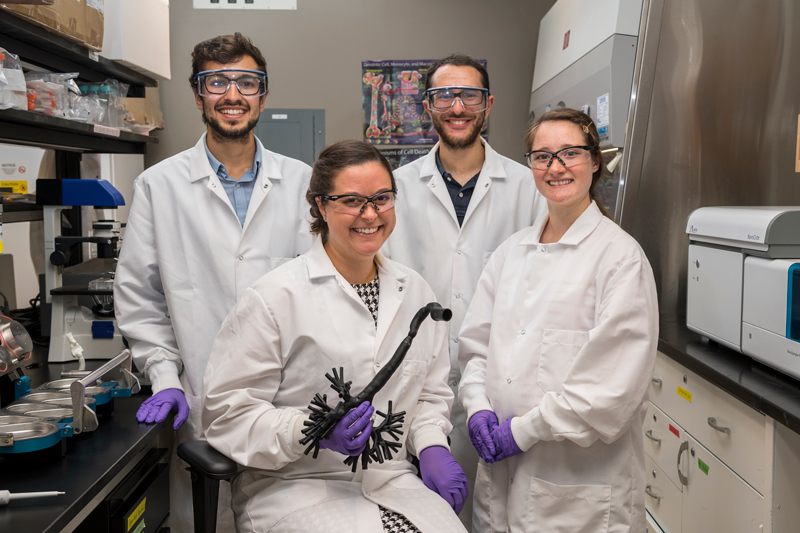 Professor Cathy Fromen works in her lab in Colburn to determine cell life in lungs of patients along with her students Zachary Stillman (with yamaka), Emily Kolewe (only female student), and Bader Jarai.