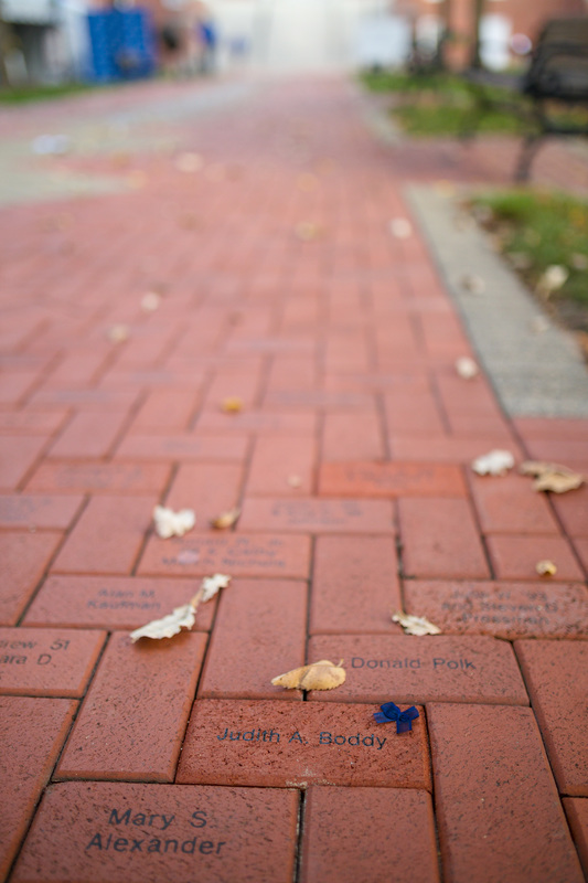 Up-close photo of an inscribed red brick on the Diamonds Walkway on Delaware's campus.