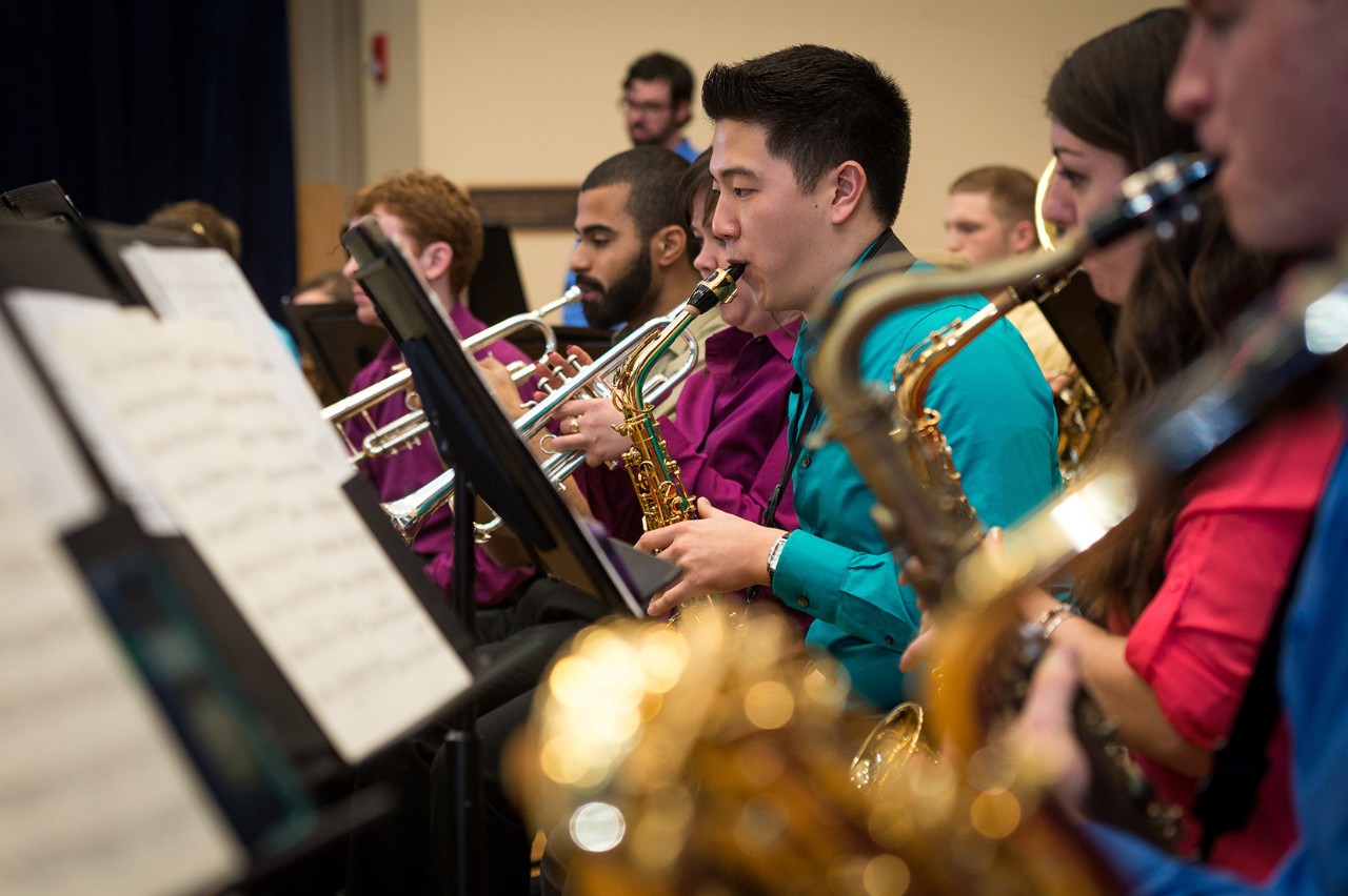 Members of the UD band play brass instruments.