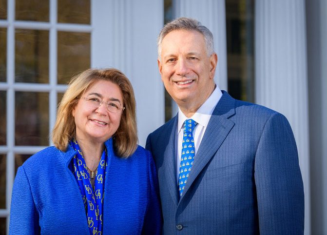 Image of Dennis and Eleni Assanis standing outside on the University of Delaware campus. . 