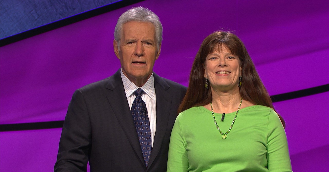 Patricia Greiner, AS75 poses with Jeopardy host Alex Trebek.