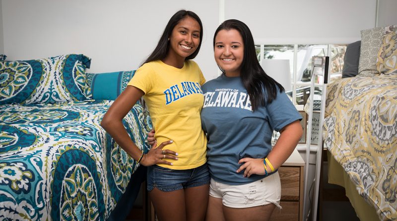 two female roommates standing in their residence hall room