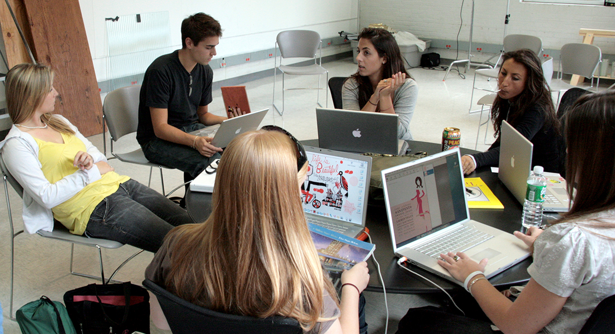 Visual communications students work together in class.
