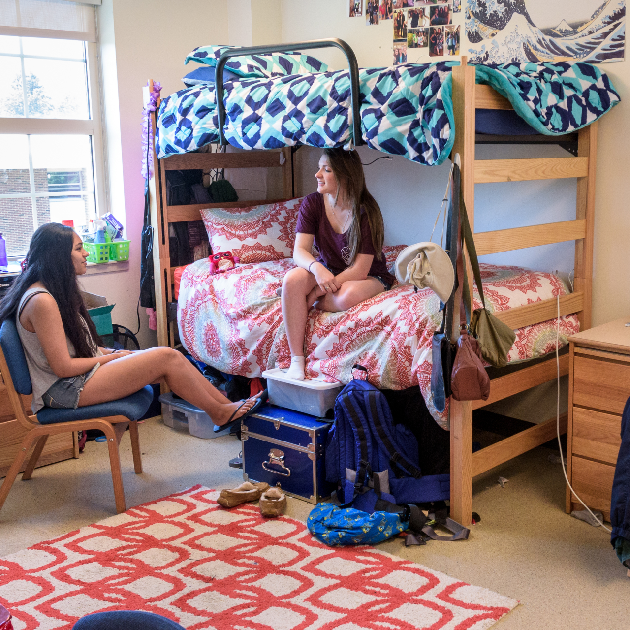 two students sitting in a room inside Redding Residence Hall