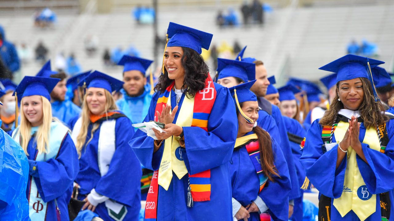 students standing in graduation regalia at university of delaware 2021 commencement