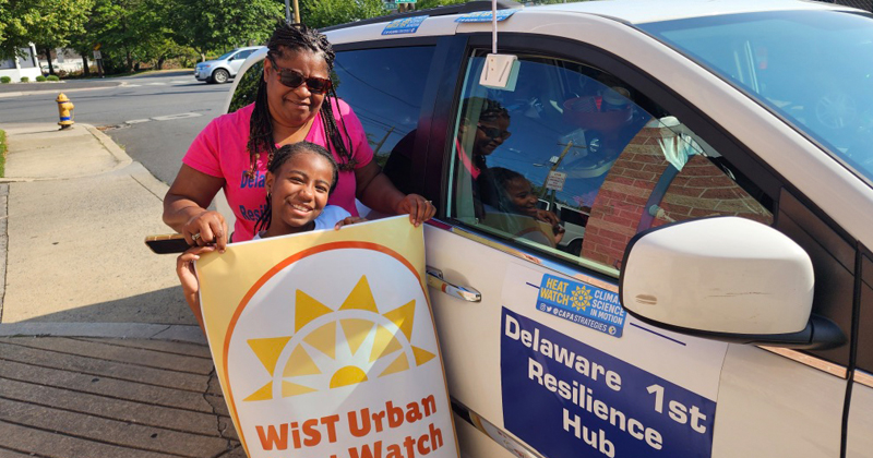 Stacey Henry, founder of the Delaware Resilience Hub, and her daughter Mylee volunteered to collect data for the 2023 WiST (Wilmington and Surrounding Townships) Heat Watch campaign. Pictured here next to their Resilience Hub vehicile.