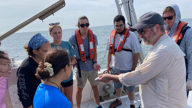 University of Delaware students on a boat with professor
