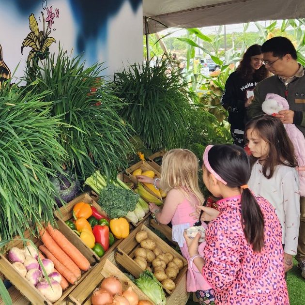 FMC produce display with community members