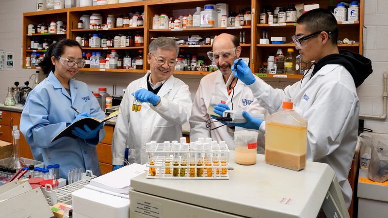 Dr. Daniel Cha, Engineering, works with Inyoung Kim, PhD student (blue coat) studying COD vials (Chemical Oxygen Demand) to see how much waste is in the sample while Dr. MIchael Chajes, Engineering, works with Gabe Chao on measuring the amount Ph, Temp, DO (Dissolve Oxygen) to figure out the total suspended solids in the materials taken from the food digestor at Ceasar Rodney Dining Hall.  