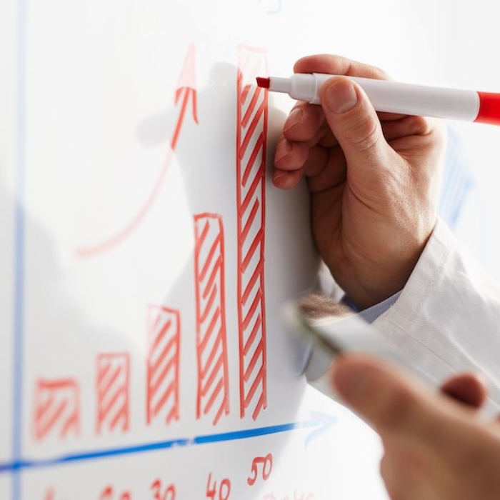 Drawing a chart on a whiteboard.