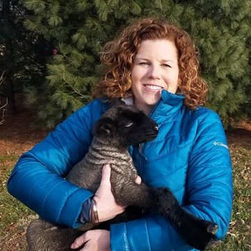 She is holding a goat