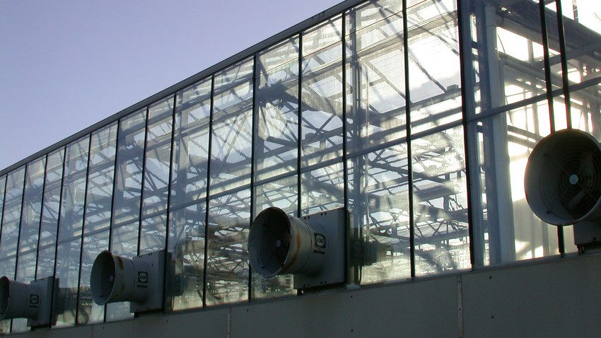 A close up photo to fans on the outside of Fischer Greenhouse.
