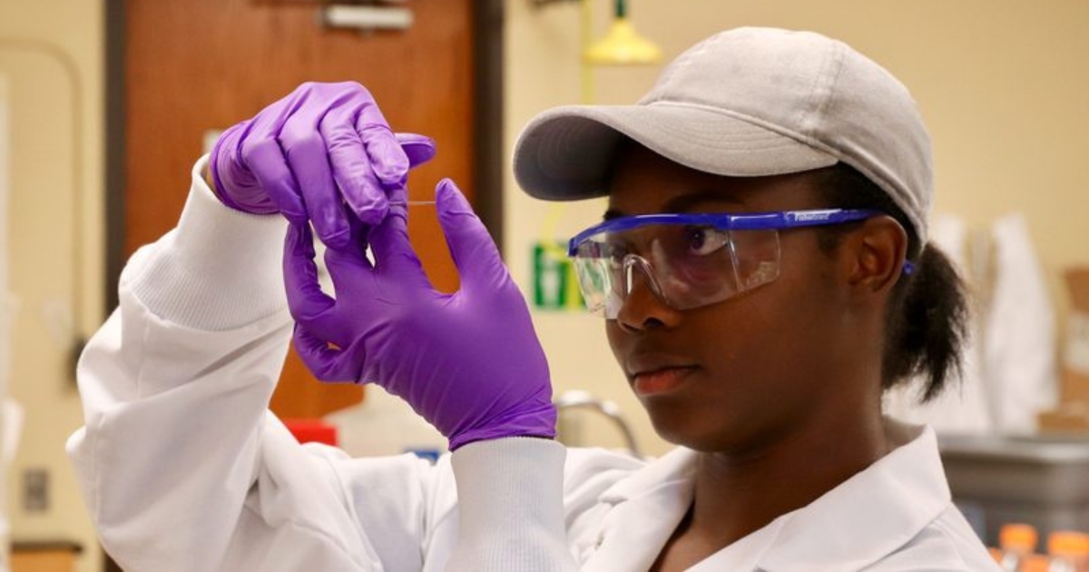 A close-up a student doing lab work.