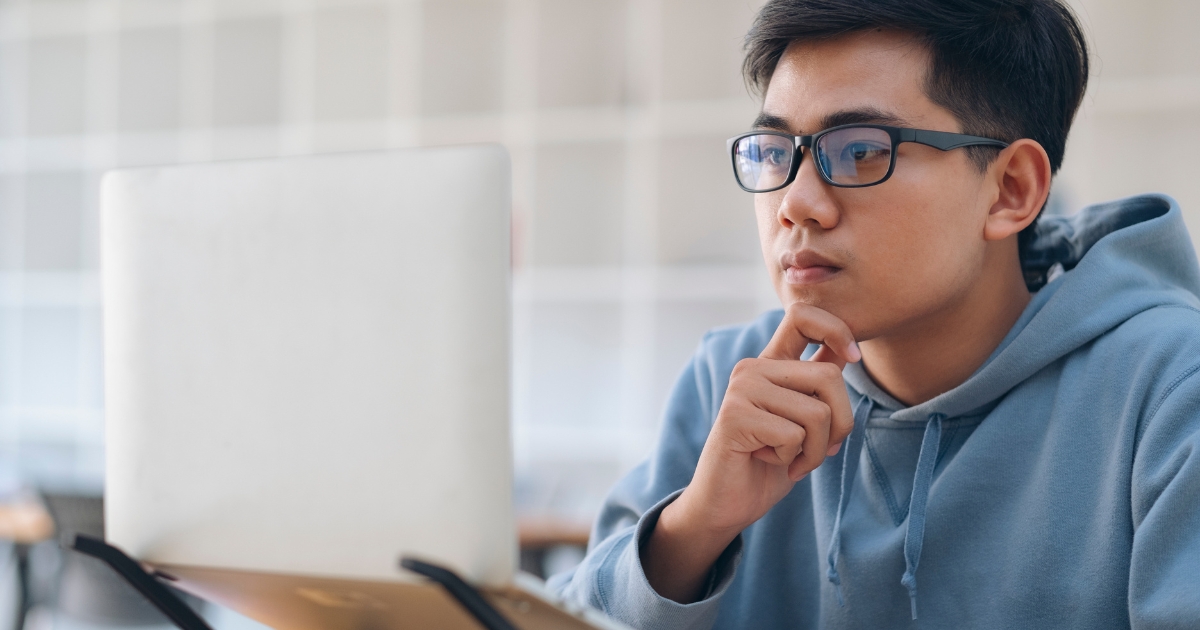 A stat student working on coursework from his personal computer at home.