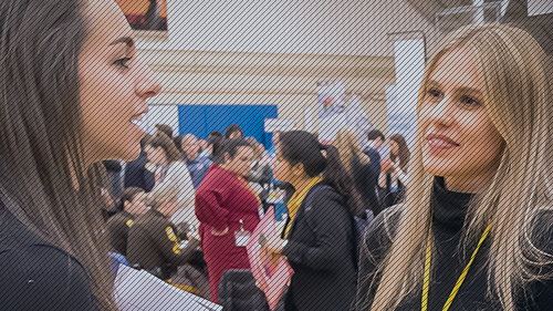Explore Majors & Career Communities Photo of two students talking at a career fair