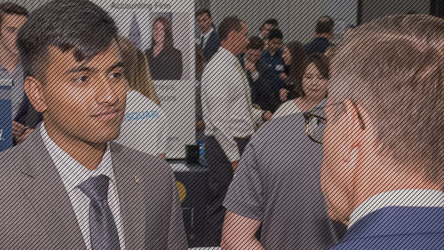Prepare for Jobs & Internships Photo of student speaking with representative at career fair