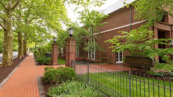 Exterior photo of Center for Fine Arts with green trees