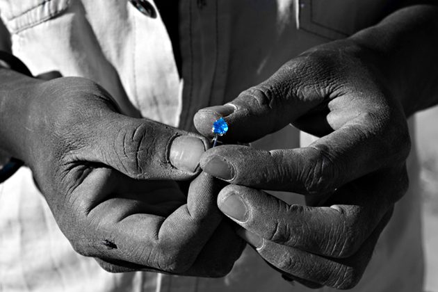 Close-up of hands holding a gemstone