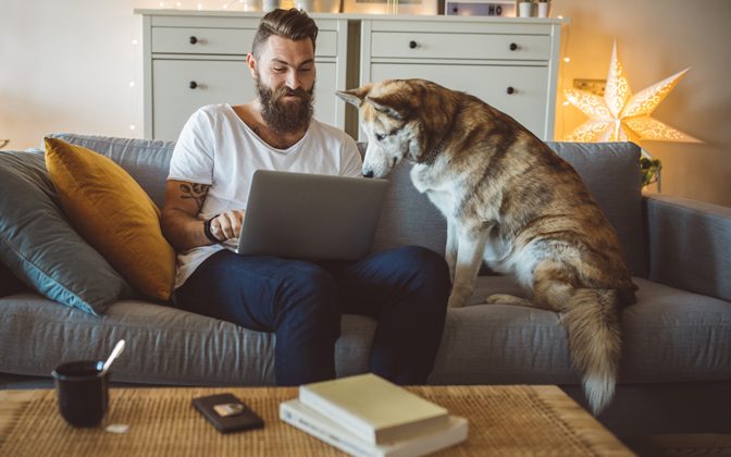 man with dog at computer