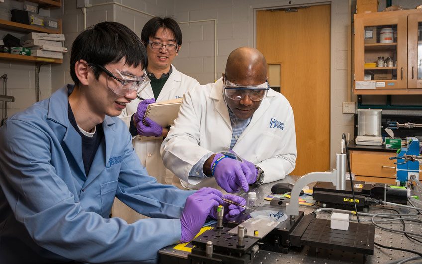 Dr. Thomas Epps, Chemical & Biomolecular Engineering, who works on Polymer batteries with his graduate students Ming Luo (blue lab coat) and Wei-Fan Kuan (with lab notebook) in their lab in Colburn.