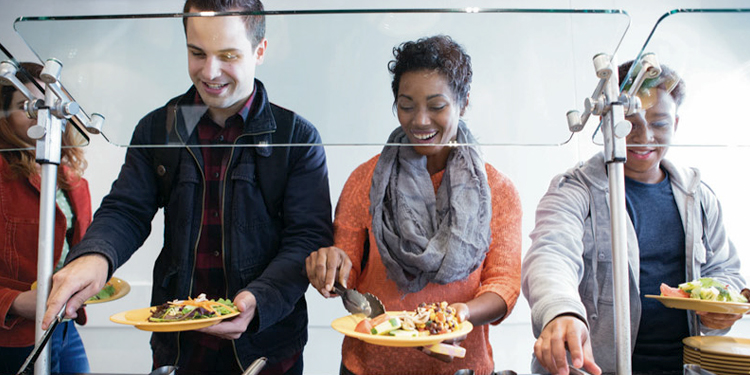 Three people dishing up food