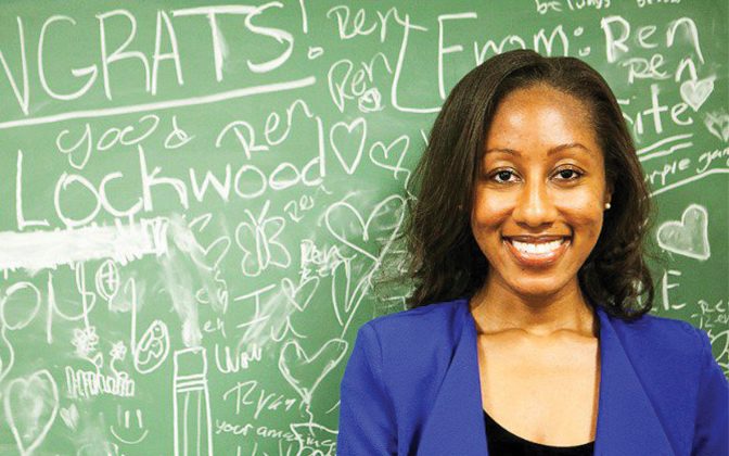 UD alumna Ashley Lockwood stands in front of a chalkboard of congratulations from her students after she was named 2023 Delaware Teacher of the Year.