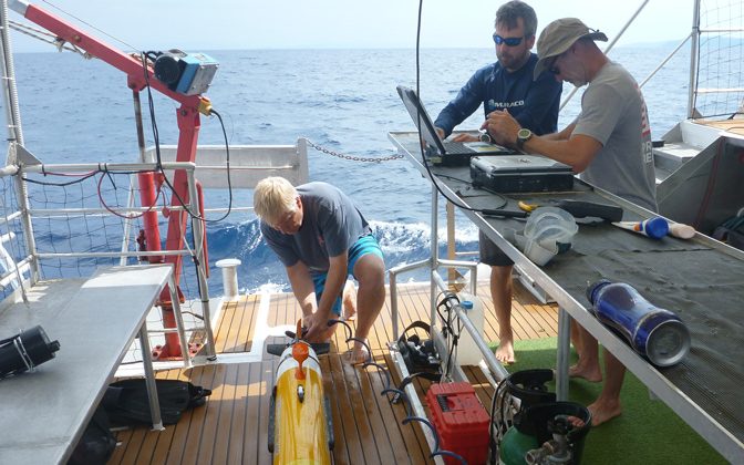 University of Delaware’s Mark Moline (left), professor of marine studies, rinses the AUV after its survey in Croatia while Matthew Breece, research scientist, and Erik White, senior engineer, download and analyze the data.