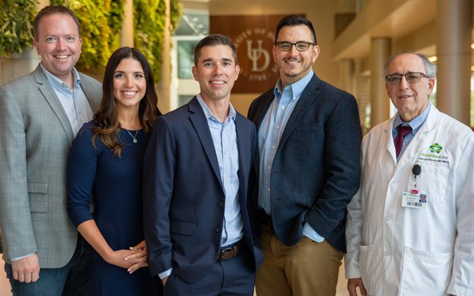 Group photo. The new Delaware Center for Cognitive Aging Research at UD, funded by an initial $150,000 investment from the College of Health Sciences Dean’s Office, aims to stimulate new NIH-funded research and grow the number of Alzheimer’s disease and related dementia researchers at UD. The effort is led by the founders (center), Christopher Martens, assistant professor of kinesiology and applied physiology, and Matthew Cohen, associate professor of communication sciences and disorders (CSCD). Also pictured and on the center’s executive board are (left): Curtis Johnson, biomedical engineering assistant professor; Alyssa Lanzi, CSCD research assistant professor; and Dr. James Ellison, Swank Foundation Endowed Chair (far right).