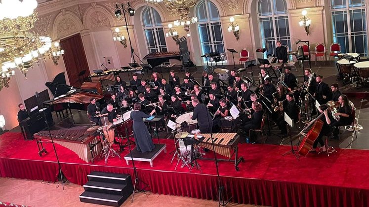 The UD Wind Ensemble performs for an international audience at the 2022 WASBE Conference, Great Hall at Žofín Palace.