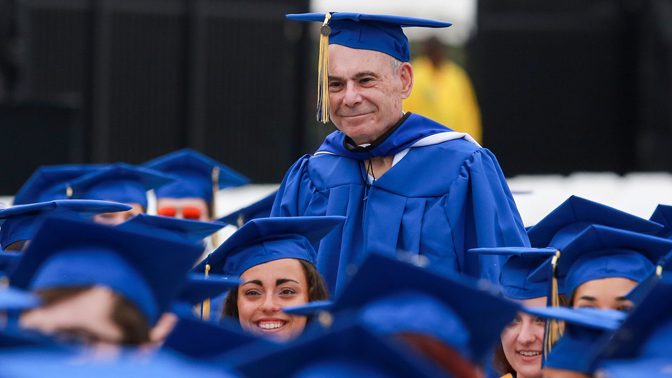 Eighty-years old, Steven Goodhart stands among fellow University of Delaware graduates at the College of Arts and Sciences Convocation ceremony on May 27.