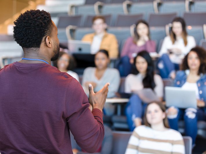 Students in a classroom listening to a workshop