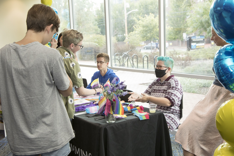 Members of the Lavender Programming Board chat with students