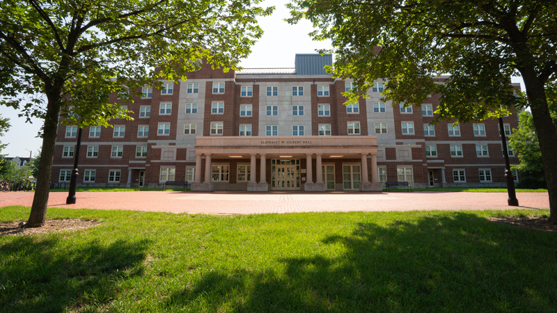 Eliphialet Gilbert Residence Hall with a brick walkway along the front of the building.