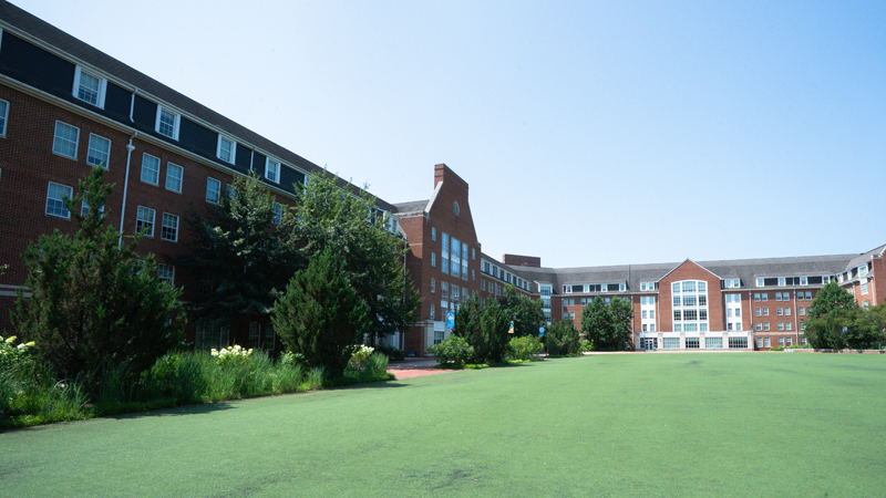 View of Independence East and West Residence Halls with a large portion of the Independence Turf field visible in front of the building.