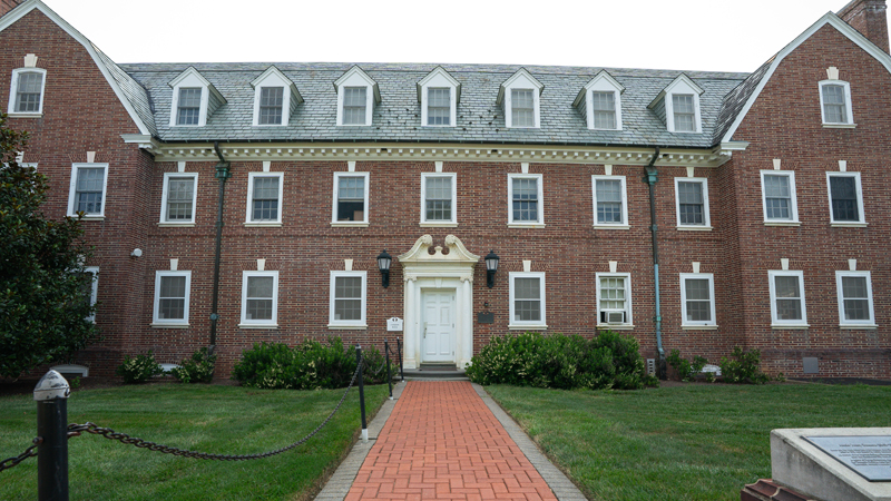 Cannon Residence Hall with a brick walkway leading up to the main building entrance.