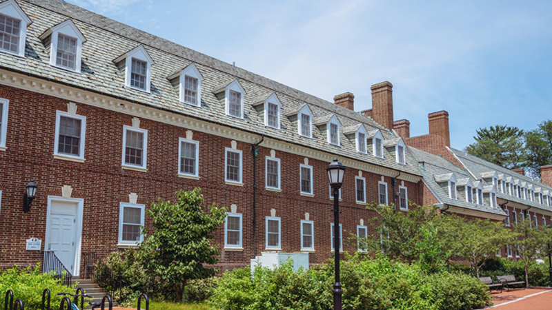 View of back of New Castle and Cannon Residence Halls with a lot of greenery around the front of the buildings.