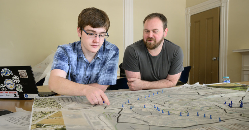 two men studying a coastal map of Delaware