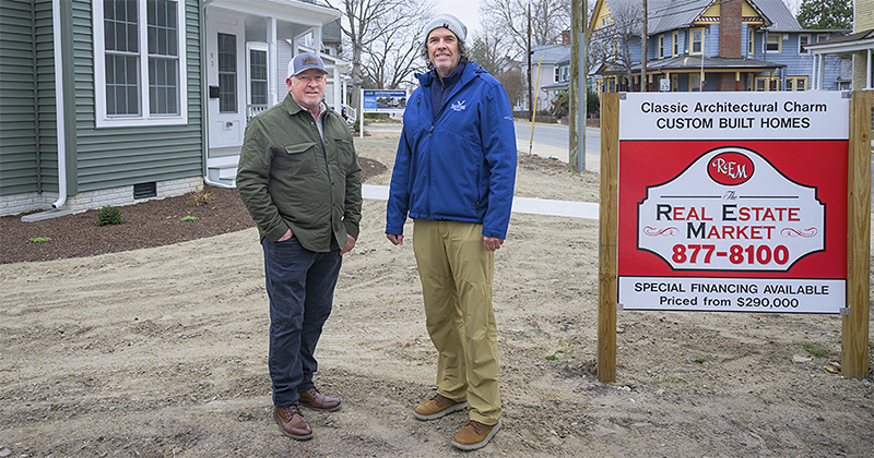 image of two men standing outside a newly refurbished home for sale in Laurel