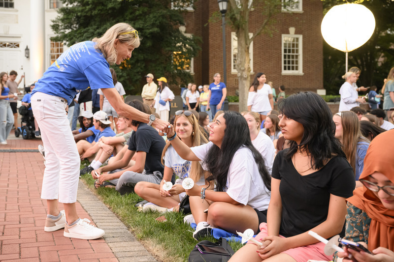 President Laura Carlson greeting students at the 2025 Twilight Induction Ceremony