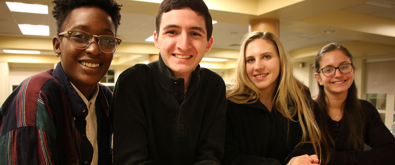 four students standing together